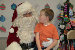 Cole Hall tells Santa what he would like for Christmas during the pancake supper at the Phenix Fire House. 