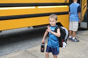 First-grader Aaron Howard leaving his school bus at Phenix Elementary.